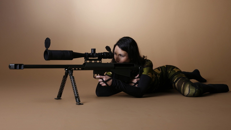 studio shot, sitting, portrait, hairstyle, aggression, weapon, indoors, gun, real people, front view, camouflage, one person, Barrett .50 Cal, casual clothing