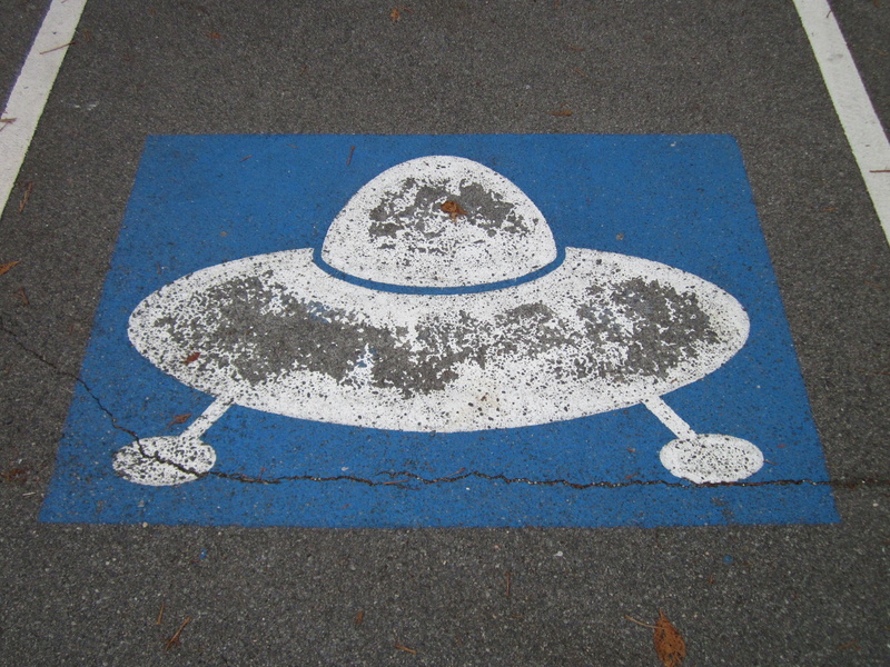 blue, symbol, road marking, ufo, road, parking space, high angle view, nature, marking, parking lot, 2K, pictogram, sign, shape, outdoors, geometric shape
