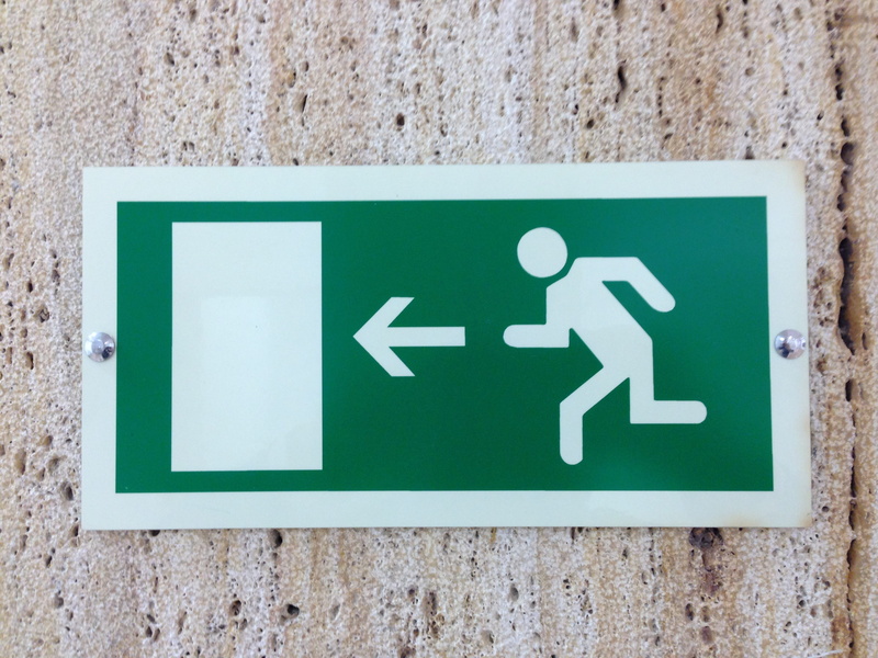 emergency, communication, characters, escape route, indoors, day, wall, text, symbol, directional sign, green color, information symbol, guidance, output