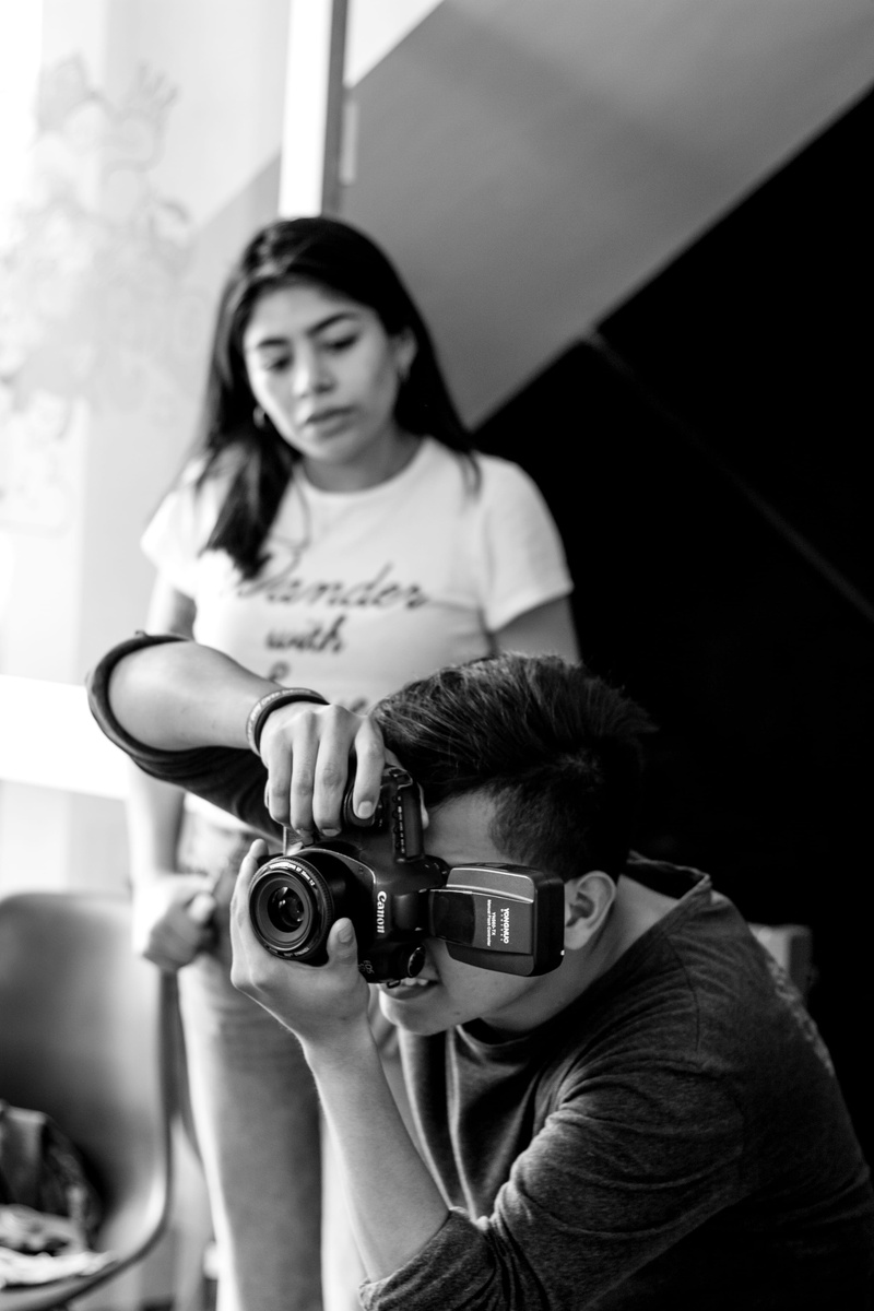 casual clothing, mindset, holding, portrait, 4K, sitting, women, camera - photographic equipment, real people, infocus, indoors, growth mindset, technology