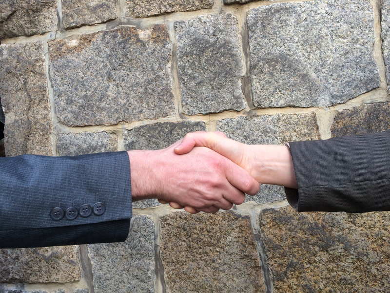 2K, togetherness, people, men, outdoors, teamwork, shaking hands, close-up, partnership - teamwork, architecture, businessman, stone wall, welcome, two people