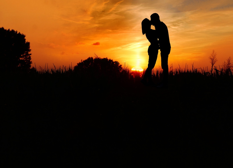 real people, silhouette, couple kissing, adult, together, lifestyles, couple, orange color, positive emotion, cloud - sky, girl, bonding, tenderness, silhouette couple
