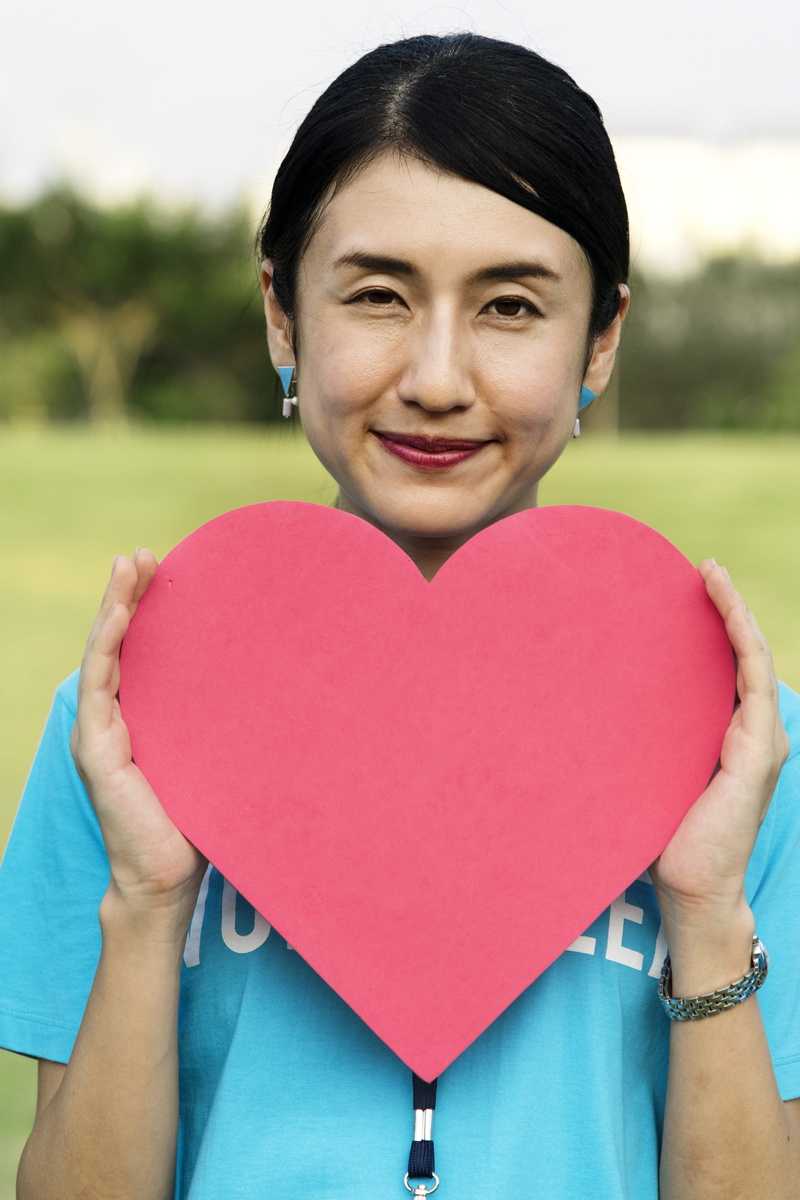 love, real people, icon, lifestyles, one person, community, looking at camera, charity, women, outdoors, kindness, participation, day, positive emotion
