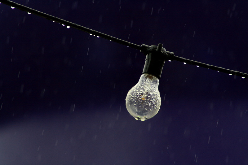 single object, incandescent, electricity, black color, raindrops, lighting equipment, wet, copy space, shiny, focus on foreground, wire, dark, indoors