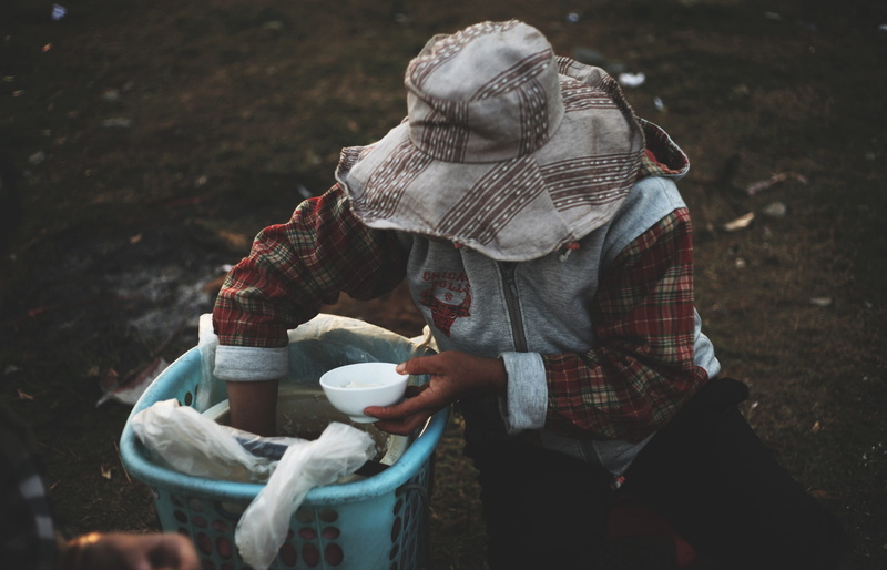 struggle, blue, poverty, feeding, real people, hungry, field, reaching, adult, meal, poor, helper, volunteer, standing, bucket, focus on foreground, casual clothing
