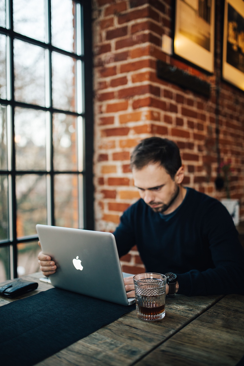 casual Clothing, surfing the Net, brick, workplace, home Interior, computer, real people, adult, only men, looking, macbook pro, connection, drink, window