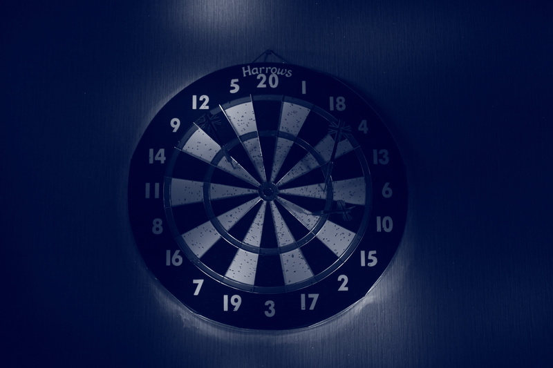 the purpose of the, wheel, leisure games, no people, navigational compass, championship, still life, sport, Dart, studio shot, accuracy, blue background