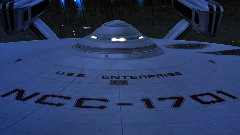 building exterior, high angle view, built structure, outdoors, travel destinations, transportation, city, building, USS Enterprise (spaceship), science fiction