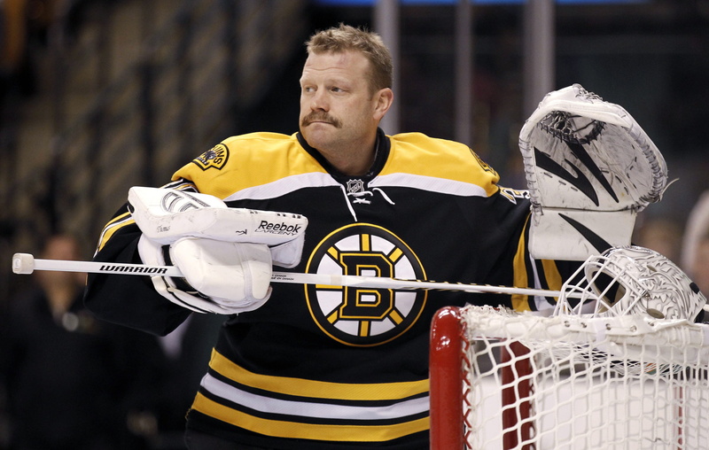 nhl, mid adult, looking away, standing, yellow, clothing, leisure activity, tim thomas, sport, mid adult men, s, lifestyles, one person, serious, athlete