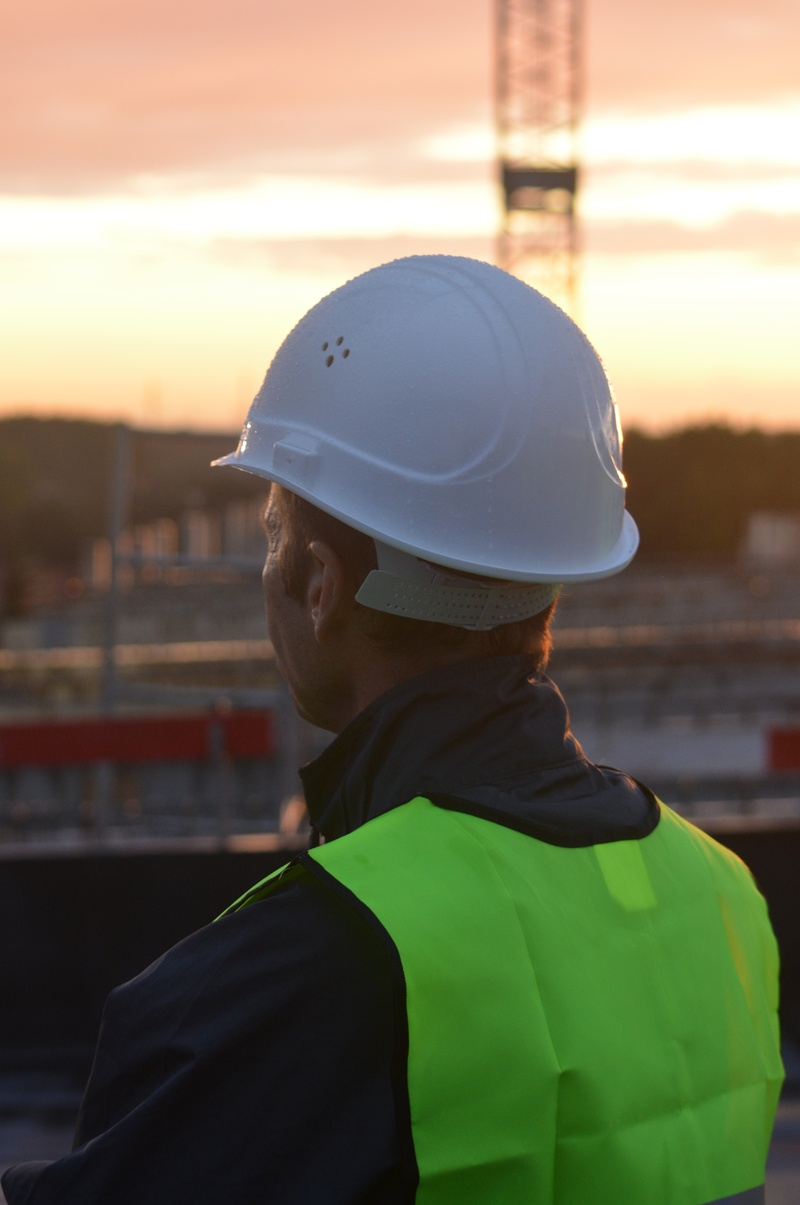real people, white, focus on foreground, man, clothing, helmet, wearing, headwear, job, construction worker, outdoors, young men, hat, rear view, manual Worker