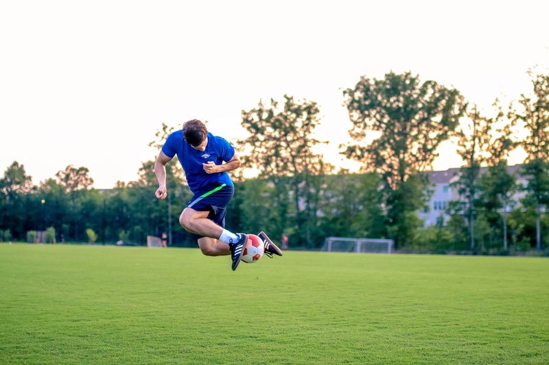 outdoors, motion, grass, clothing, futbol, soccer player, athlete, competition, soccer, healthy lifestyle, tree, vitality, training, plant, sport, young adult