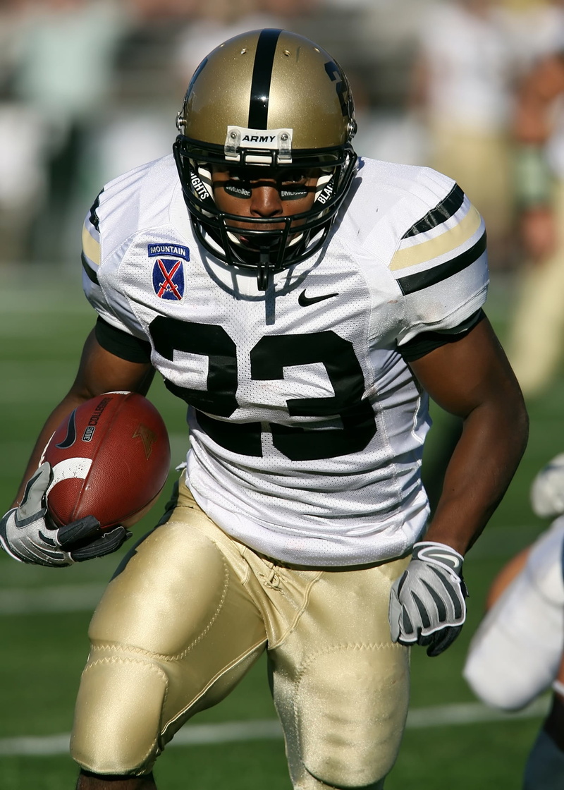 focus on foreground, football, holding, running, stadium, game, athlete, sports equipment, one person, player, baseball, playing, american football player