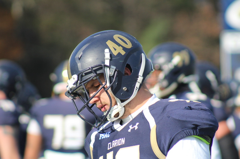 photography, american football - sport, child, tilt, teenage boys, security, nfl, helmet, wearing, day, people, uniform, athlete, wear, shift, game, focus on foreground