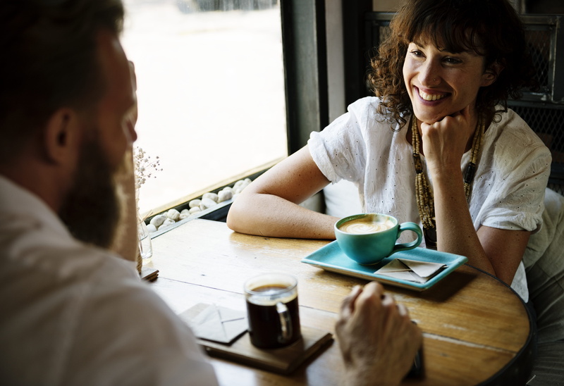 headshot, coffee cup, indoors, shirt, chat, couple - relationship, drinking, woman, sitting, coffee - drink, young adult, drinks, drink, caffeine, talk