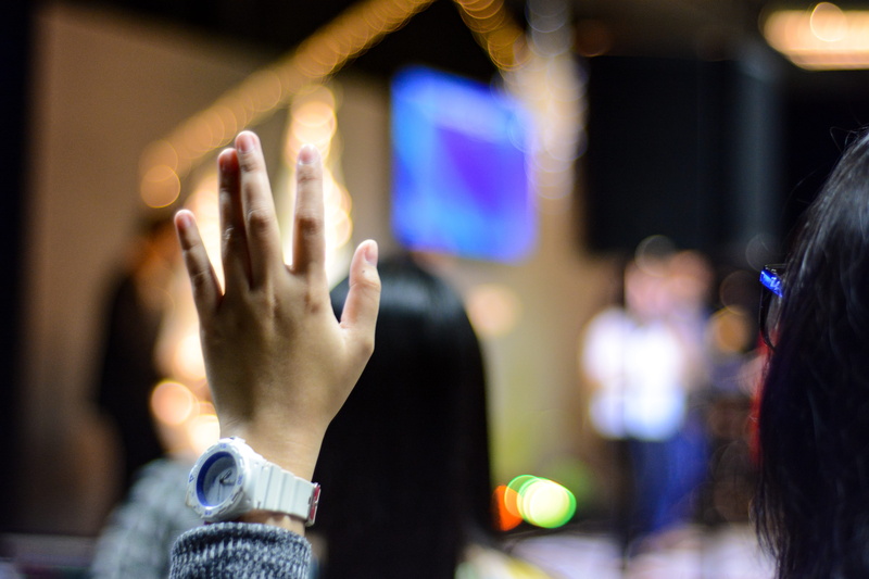 young adult, people, hands, spectator, human limb, focus on foreground, human arm, waiting, hand raised, arms raised, young women, church, adult, indoors