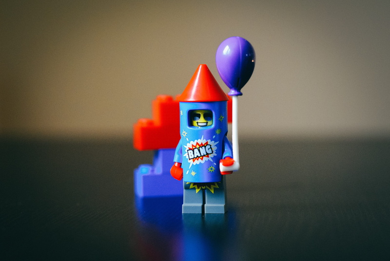 studio shot, minifig, firecracker, representation, top, kid, teal, macro, plastic, multi colored, childhood, firework, colored background, costume, toy