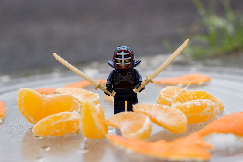 men, humor, arms raised, closeup, glass, clothing, nature, citrus fruit, tangerine, selective focus, LEGO, day, outdoors, miniatures, orange color, depth of field
