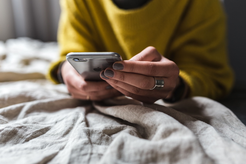 clothing, text Messaging, textile, lifestyles, home, adult, influencer, comfortable, technology, mobile Phone, young, using, caucasian Ethnicity, bed, laptop