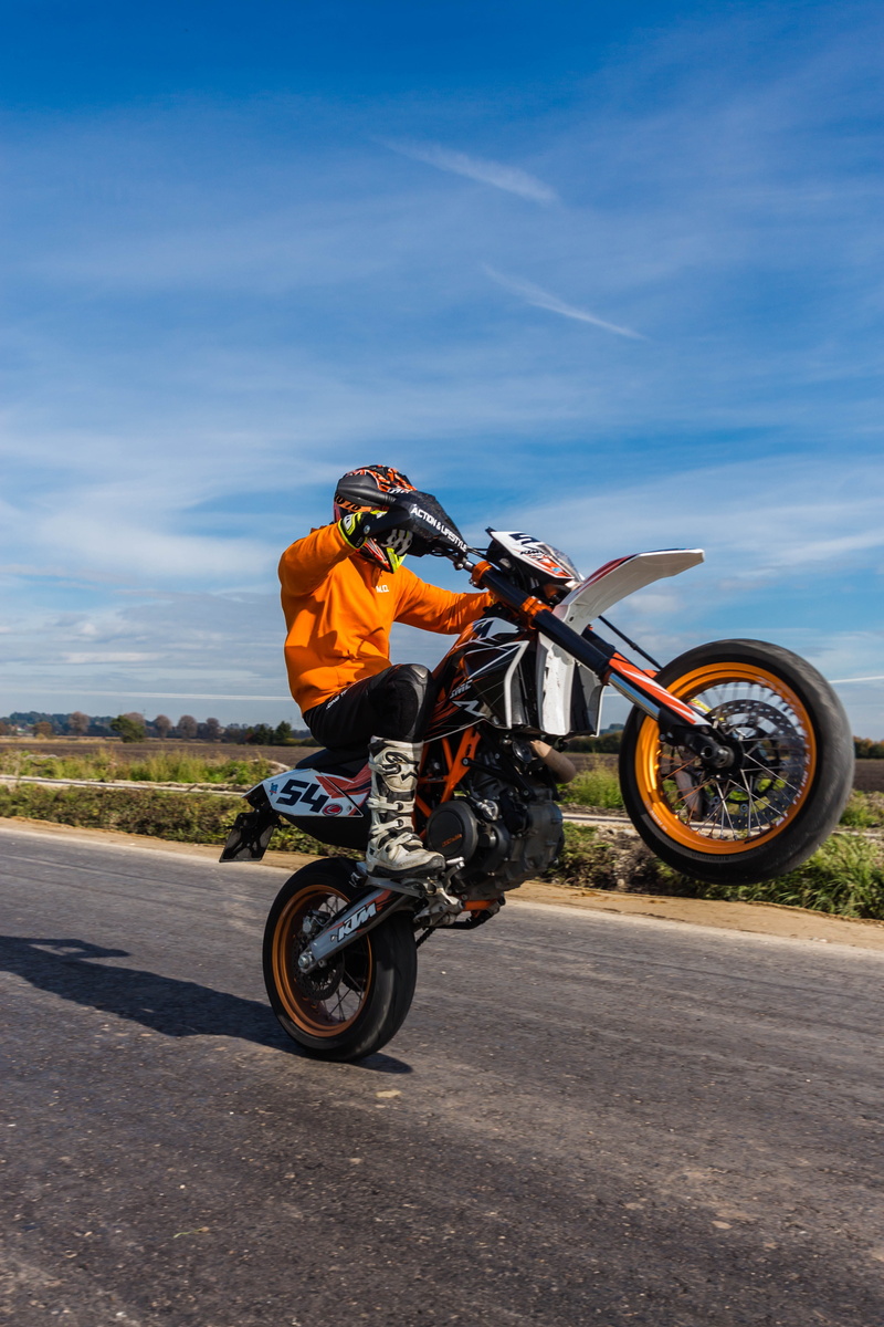 landscape, headwear, wheelie, biker, mode of transportation, day, 5K, summer, road, motorcycle, sporty, crash helmet, ride, men, transportation, skill