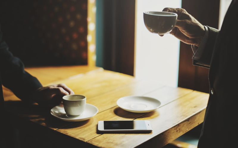 men, furniture, communication, break, beverage, cup, coffee, human hand, real people, blur, room, digital device, indoors, rest, wireless technology, employee