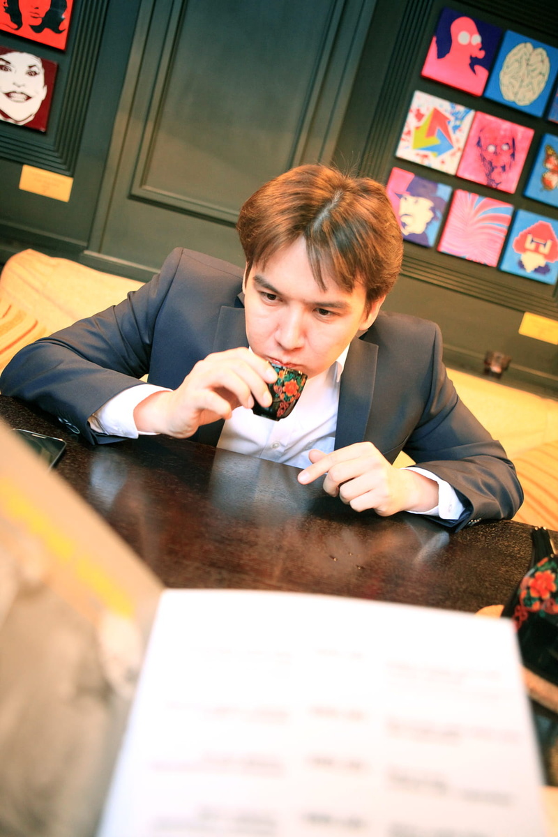 people, males, leisure, indoors, break, relaxing, drink, furniture, focus on background, businesspeople, tea, happy, real people, one, young, person, headshot