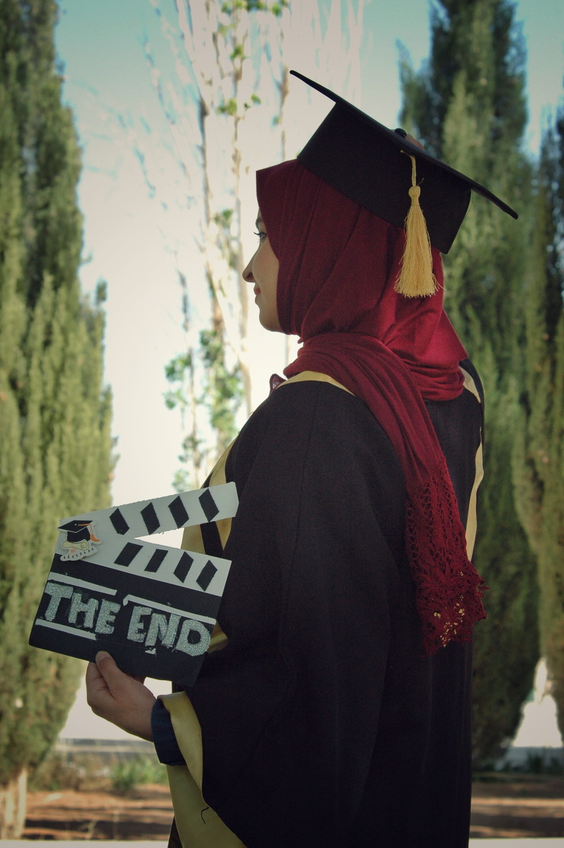 waist up, wearing, men, holding, lifestyles, education, profile view, daytime, dress, headscarf, hat, graduation, one person, three quarter length, side view