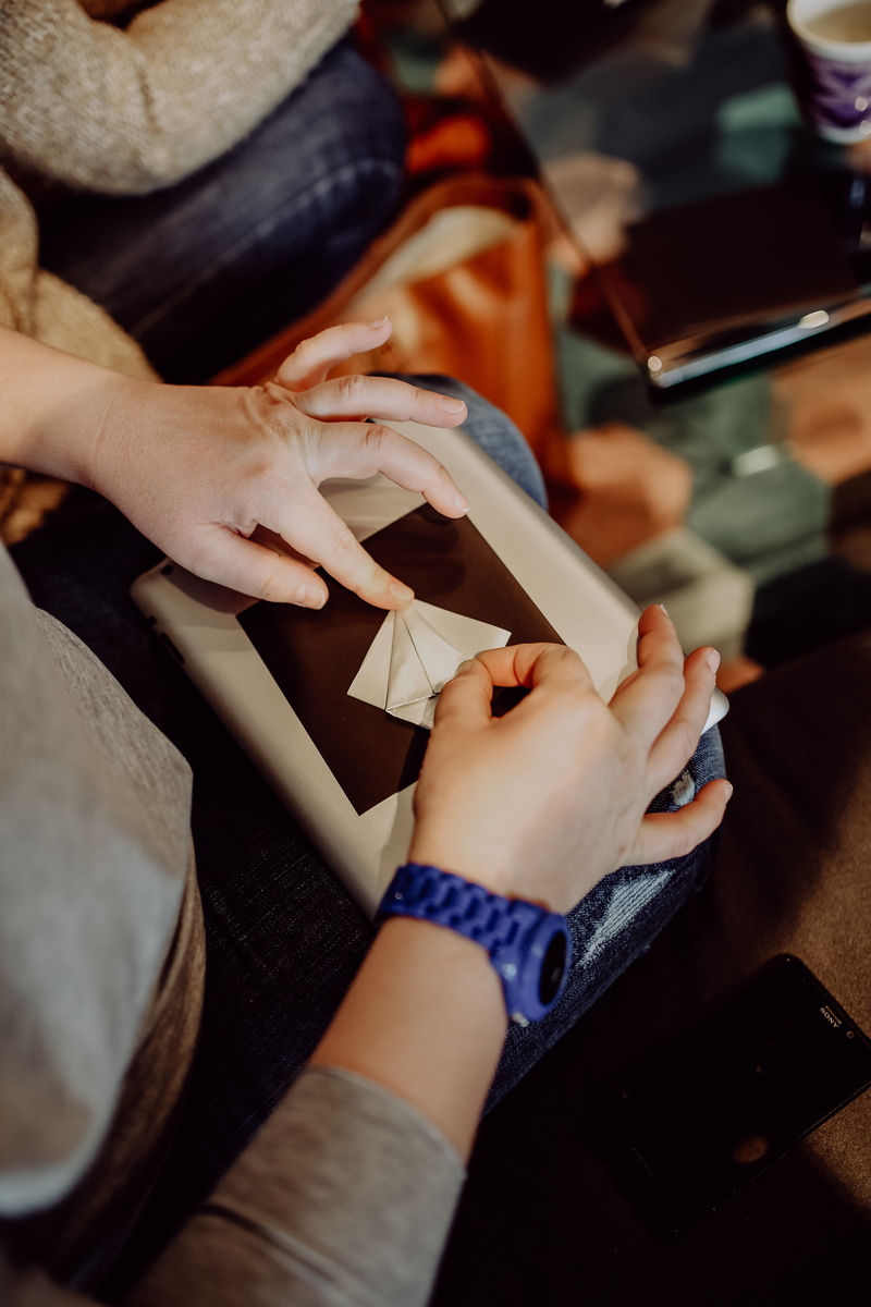 indoors, body part, paper, making, folding, close-up, high angle view, 5K, art and craft, real people, artwork, origami, togetherness, craft, finger, holding