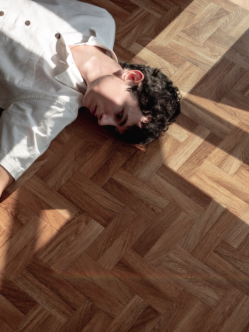 floor, male, one Person, lying Down, collared, smiling, shadow, caucasian Ethnicity, males, directly Above, indoors, one Man Only, white shirt, male Beauty