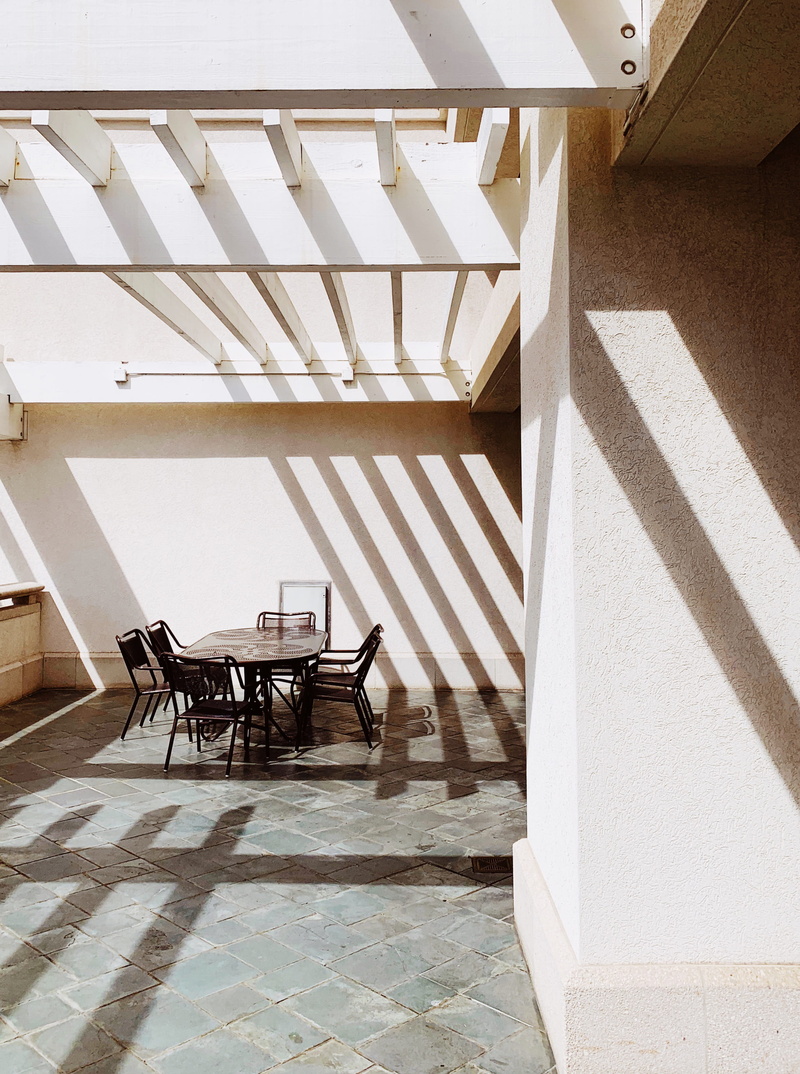 patio, oval, plywood, table, interior design, railing, no people, indoors, built structure, day, sunlight, tiled floor, wood, wooden, empty, floor, high angle view