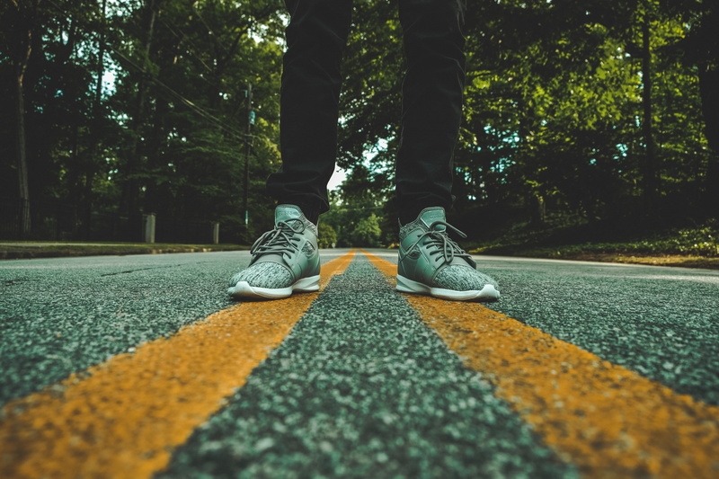 middle, human limb, pair, one person, street, outdoors, symmetry, concrete, nature, human foot, stand, standing, body part, lane, open road, person, lifestyles