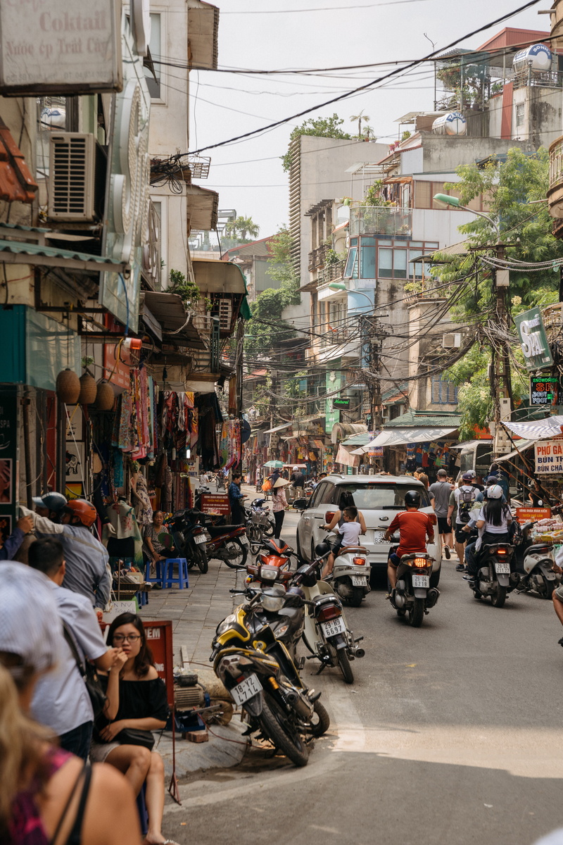 men, transportation system, vehicles, scooters, real people, people, Hanoi, architecture, outdoors, motorbikes, building, road, group, crowd, sidewalk