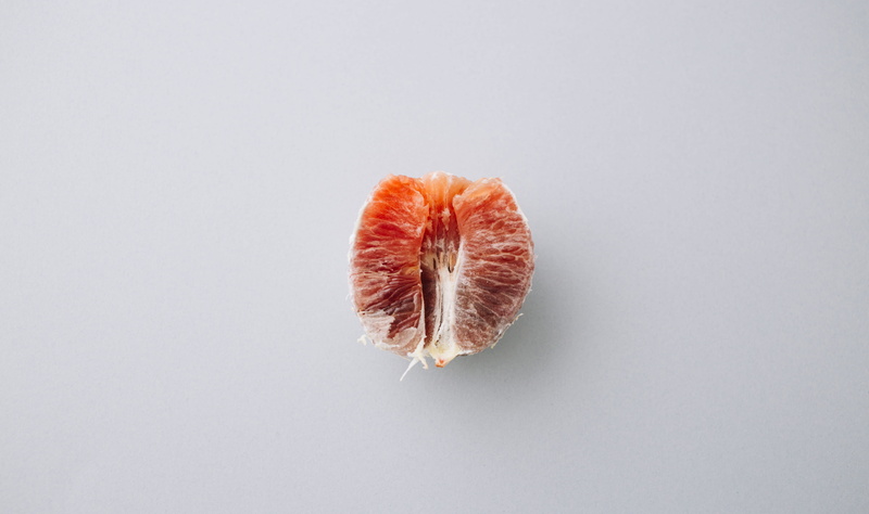 no people, studio shot, white background, directly above, orange color, 5K, close-up, single object, grapefruit, still life, indoors, fruit, gray, citrus