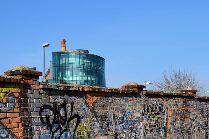 art and craft, graffiti, fencing, creativity, fuel and power generation, copy space, wall - building feature, blue, sky, factory, architecture, wall, clear sky