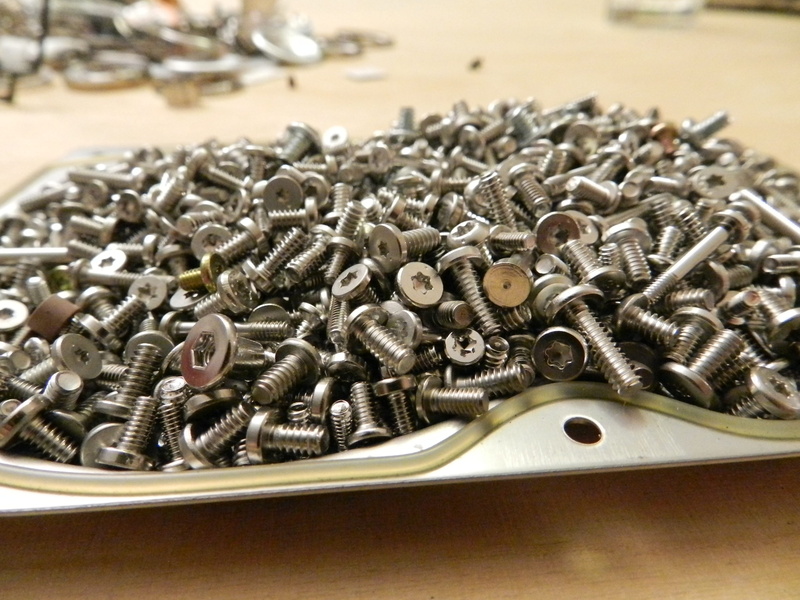 industry, bolt, indoors, precision, spiral, heap, torx, work tool, table, thread, stack, metal, high angle view, silver colored, nut - fastener, alloy