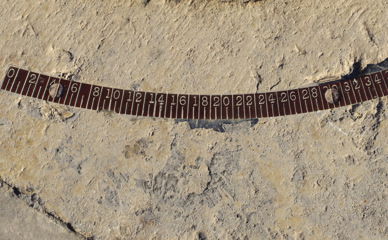 western script, rough, measure, day, high angle view, pattern, figures, metal, sand, textured, metrics, wall, text, outdoors, ruler, number, industry, measurement