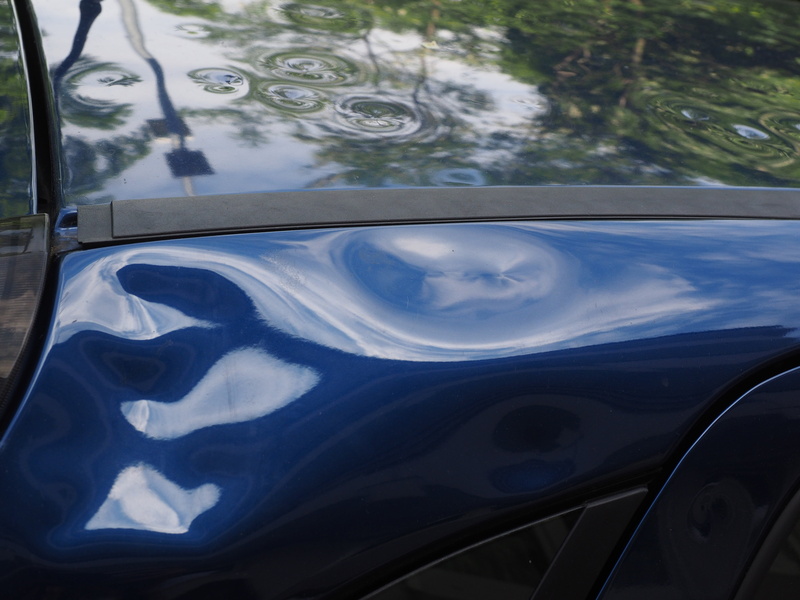 blue, transparent, dents, car roof, hail dellen, beulen, paint damage, focus on foreground, water, day, no people, wheel, outdoors, glass - material, close-up