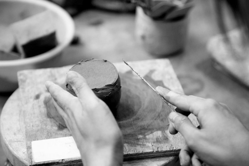hand, clay, indoors, human body part, human hand, occupation, qualitative, porcelain, skill, selective focus, black and white, one person, traditional