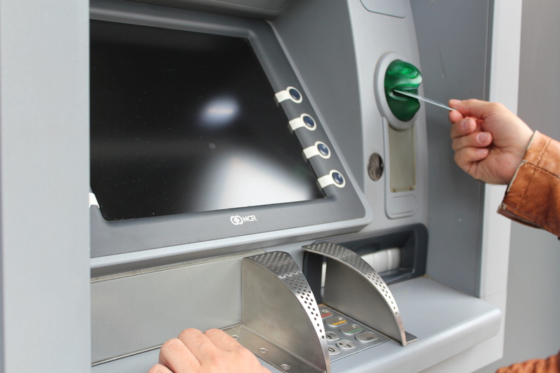 card slot, indoors, lifestyles, inserting, card, map, motor vehicle, credit card, convenience, atm, hand, finance, human hand, business, one person, withdraw cash