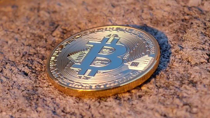 metal, single object, day, number, land, instrument of time, text, finance, 1080P, wealth, nature, outdoors, sand, high angle view, bitcoin, cryptocurrency