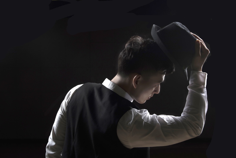 dark, holding, young adult, front view, black background, people, young men, occupation, one person, shirt, skill, concentration, 5K, gentleman, men, standing