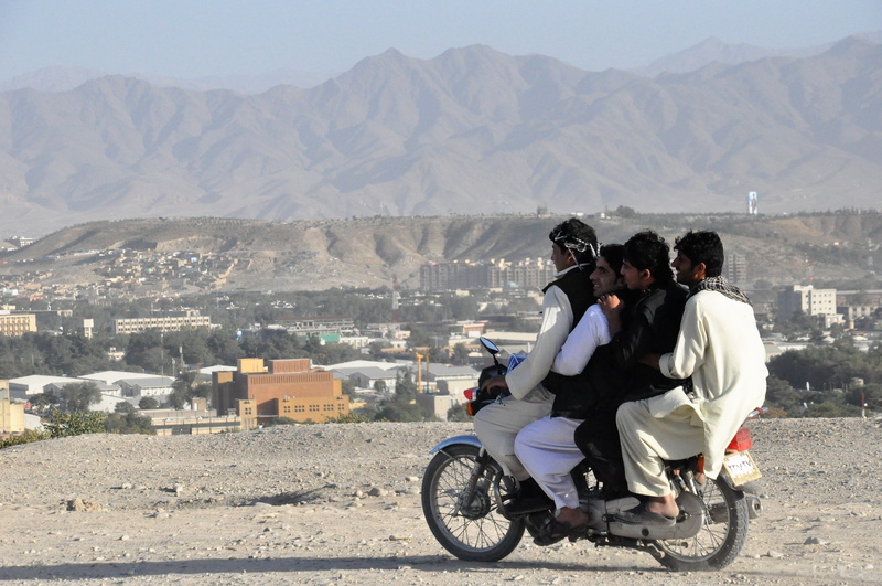 sand, mountain, mode of transportation, violation of the traffic regulations, people, mountain range, landscape, adult, city, children, riding, dirt, day