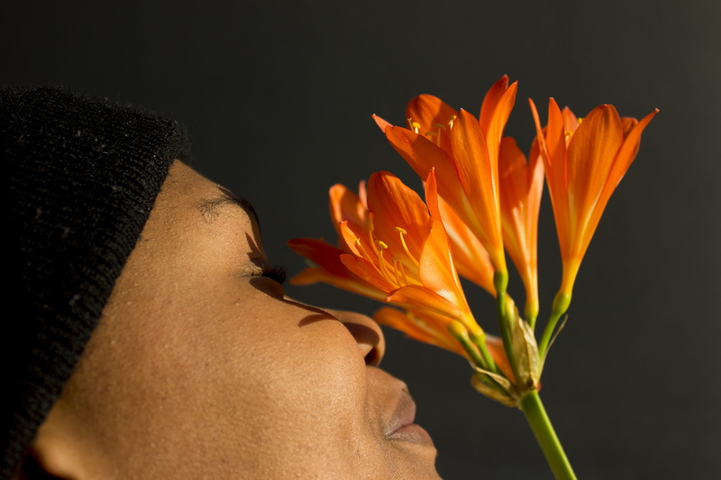 fragility, bouquet, race, africa, smile, green, orange color, inflorescence, black background, langauge, flower girl, flower, vulnerability, power, one person