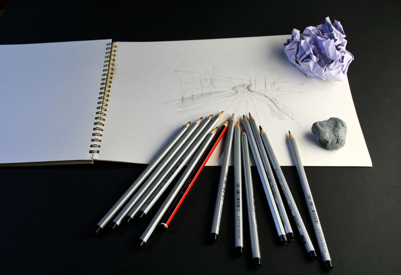 craft, indoors, sketch pad, sketch, variation, table, no people, large group of objects, black background, directly above, choice, drawing, crumpled, still life