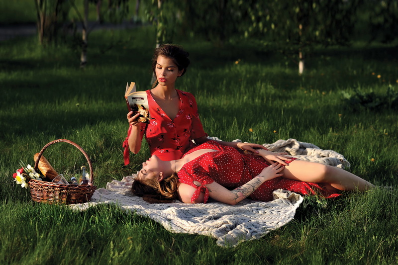 two women, inked girls, dress, cleavage, lying on back, baskets, brunette, model, women outdoors, tattoo, portrait, blankets, grass, closed eyes, picnic