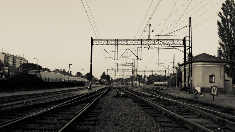 railway, clear sky, electricity, connection, rail transportation, sky, power line, direction, transportation, building, railroad track, city, urban, mode of transportation