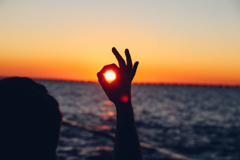 sea, arms raised, vsco, beauty in nature, sun, outdoors, vintage, artsy, leisure activity, sunlight, human body part, nature, real people, water, sky, hand