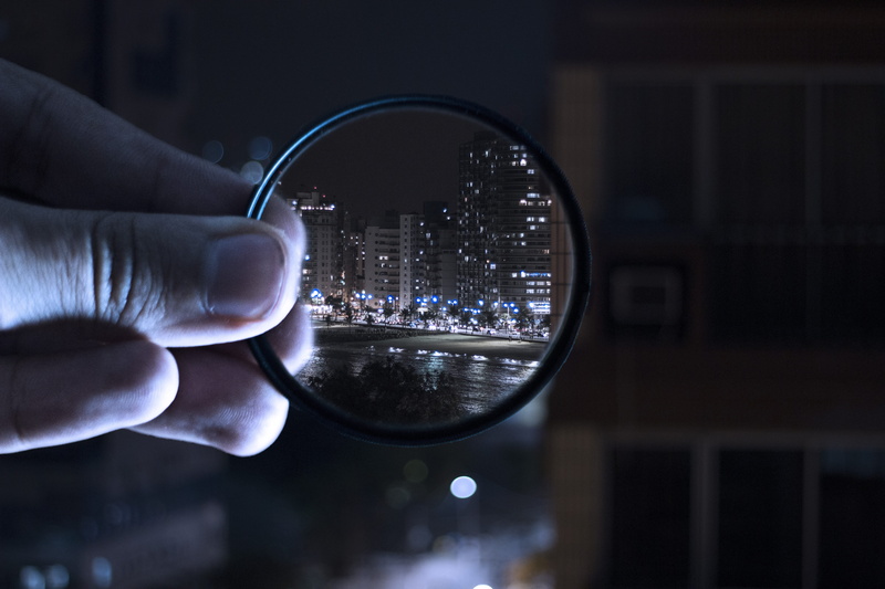 human body part, focus on foreground, illuminated, glass, magnifying glass, light, motion, filter, architecture, blur, holding, hand, adult, one person