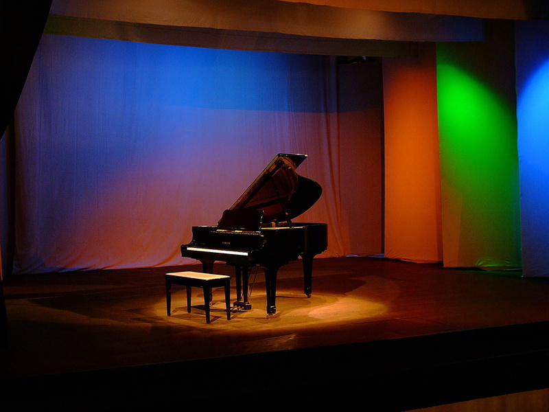 playing, instrument, seat, Music, concert, stage - performance space, Theatre, stage, indoors, acoustic, old, black, flooring, nightlife, arts culture and entertainment