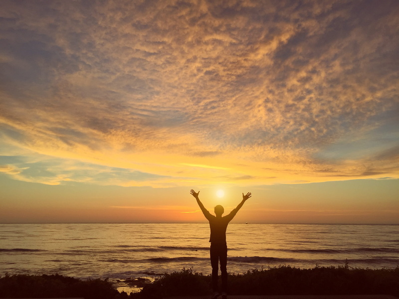 sunset, water, beauty in nature, island, human arm, sky, horizon over water, land, 2K, one person, cloud - sky, sea, beach, mesmerizing, man, standing