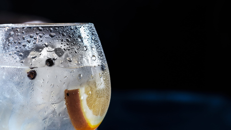 close-up, 2K, focus on foreground, cold temperature, sliced, glass, citrus, household equipment, splashing, indoors, chilled, black background, close